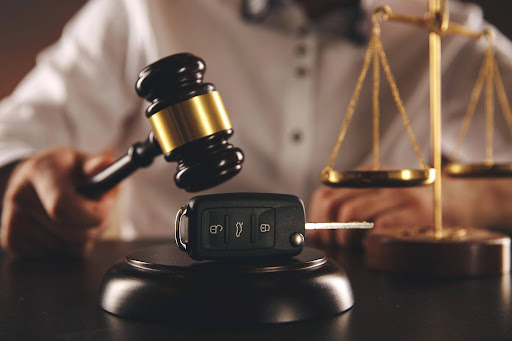 A gavel and a set of car keys on a desk. Concept for: “Can I sue someone after a car accident?” A gavel and a set of car keys on a desk. Concept for: “Can I sue someone after a car accident?”