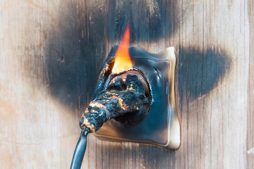 A plug from an appliance burned and melted in a wall socket, a likely cause of a product liability case. A plug from an appliance burned and melted in a wall socket, a likely cause of a product liability case.
