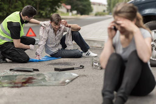 Two drivers sitting in the road at the scene of a car accident; one is being attended by a paramedic while the other speaks on a mobile phone. What happens at the crash site can influence whether you need to go to court for a car accident. Two drivers sitting in the road at the scene of a car accident; one is being attended by a paramedic while the other speaks on a mobile phone. What happens at the crash site can influence whether you need to go to court for a car accident.