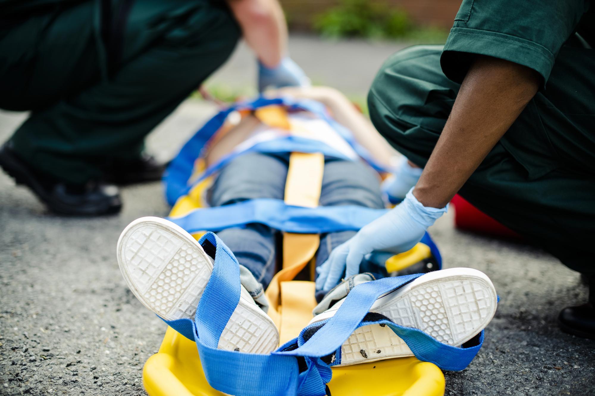 image3 Paramedics work to immobilize a critically injured patient for transport; expert witnesses can often help clarify medical matters in catastrophic injury cases.