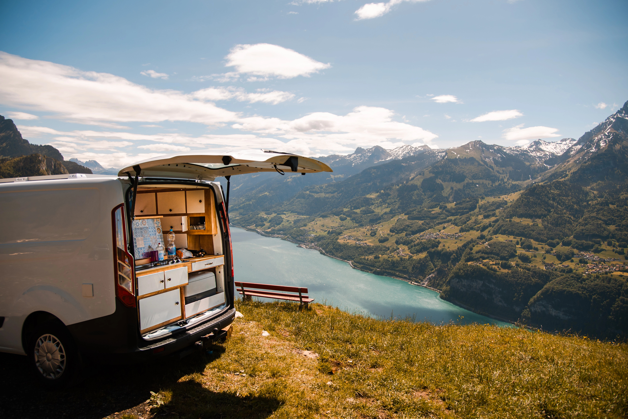 image2 Rear image of a van outfitted as a temporary residence, set against a mountain background; conversion vans can provide exciting travel opportunities but also pose risks.
